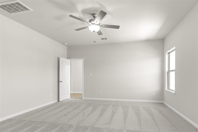 18309 Emu Ln, Manor, TX 78653 - empty room featuring light colored carpet, ceiling fan, and baseboards