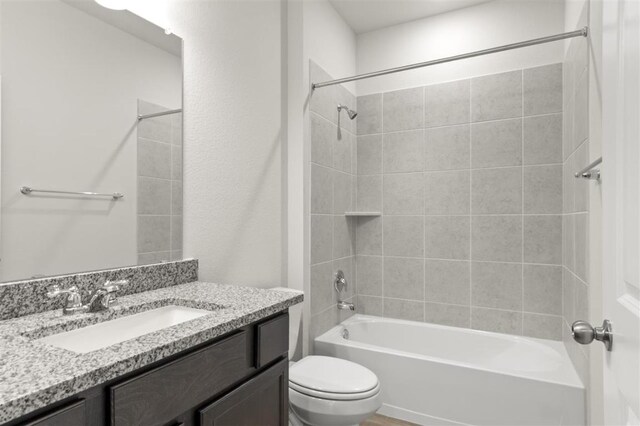 18309 Emu Ln, Manor, TX 78653 - bathroom featuring toilet, vanity, and tub / shower combination