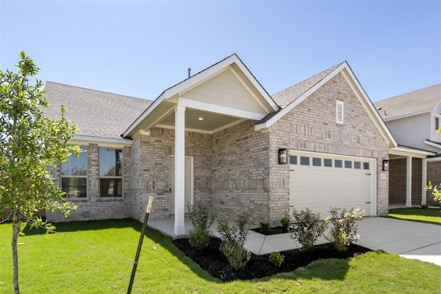 18309 Emu Ln, Manor, TX 78653 - view of front of home with a garage, a front yard, driveway, and brick siding