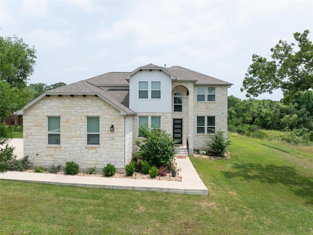 121 Black Talon Ln, Cedar Creek, TX 78612 - view of front facade featuring stone siding, roof with shingles, and a front lawn