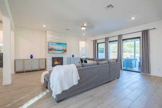 121 Black Talon Ln, Cedar Creek, TX 78612 - living room with a fireplace, recessed lighting, light wood-type flooring, a ceiling fan, and baseboards