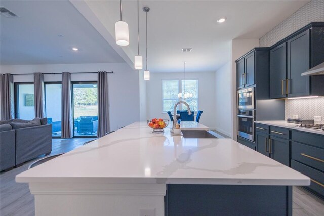 121 Black Talon Ln, Cedar Creek, TX 78612 - kitchen featuring a sink, open floor plan, plenty of natural light, a spacious island, and recessed lighting