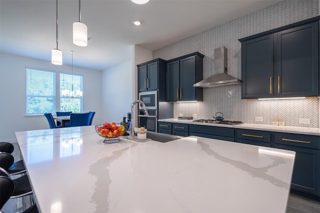 121 Black Talon Ln, Cedar Creek, TX 78612 - kitchen featuring wall chimney range hood, stainless steel appliances, backsplash, a breakfast bar, and decorative light fixtures