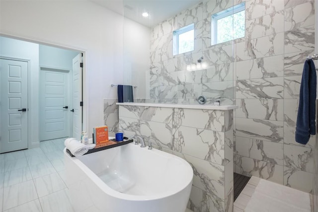 121 Black Talon Ln, Cedar Creek, TX 78612 - full bath featuring a soaking tub, marble look tile flooring, walk in shower, and tile walls