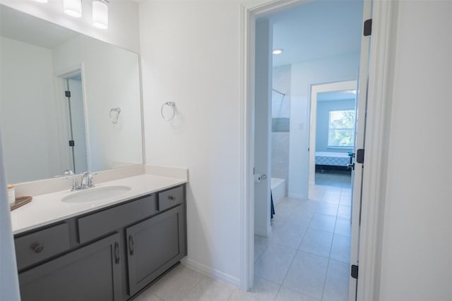 121 Black Talon Ln, Cedar Creek, TX 78612 - bathroom featuring vanity, shower / bathtub combination, tile patterned floors, and baseboards