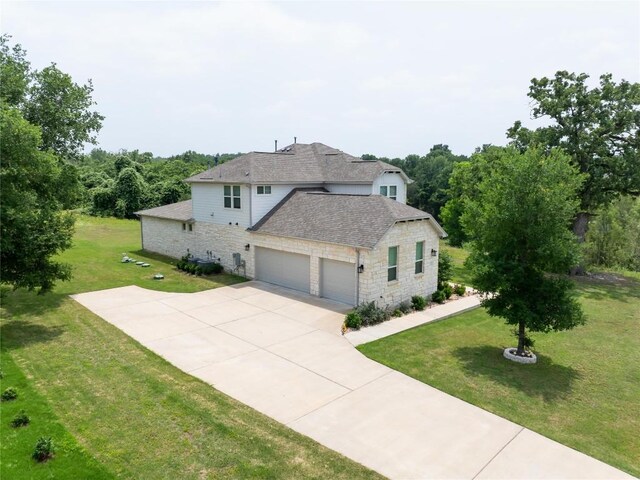 121 Black Talon Ln, Cedar Creek, TX 78612 - view of side of property with stone siding, a garage, and a yard