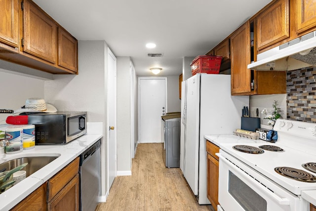 kitchen with visible vents, appliances with stainless steel finishes, under cabinet range hood, and brown cabinets
