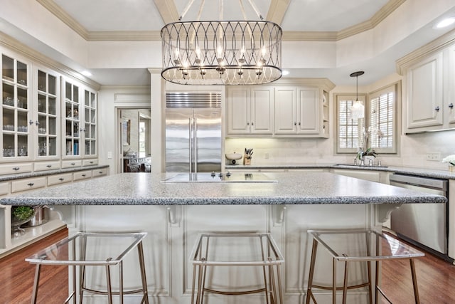 807 Terrace Mountain Dr, West Lake Hills, TX 78746 - kitchen featuring ornamental molding, glass insert cabinets, a chandelier, a sink, and stainless steel appliances