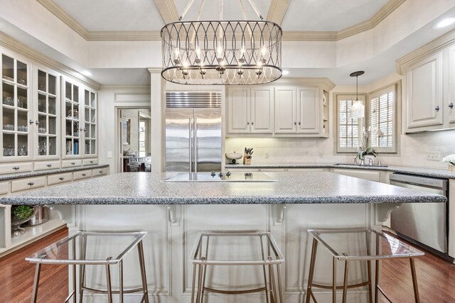 807 Terrace Mountain Dr, West Lake Hills, TX 78746 - kitchen featuring stainless steel appliances, a chandelier, ornamental molding, glass insert cabinets, and a kitchen island