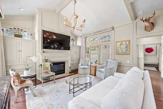 807 Terrace Mountain Dr, West Lake Hills, TX 78746 - living room featuring wood finished floors, high vaulted ceiling, a notable chandelier, a glass covered fireplace, and a decorative wall