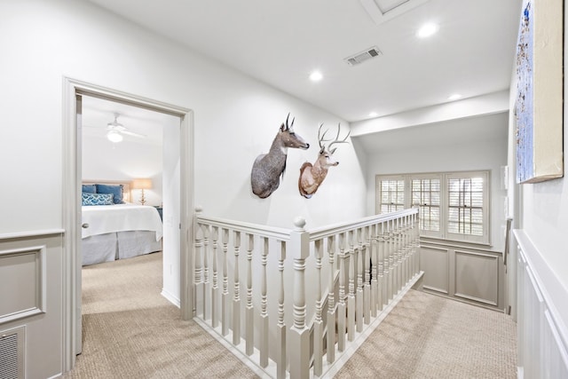 807 Terrace Mountain Dr, West Lake Hills, TX 78746 - hallway featuring visible vents, a decorative wall, recessed lighting, light colored carpet, and a wainscoted wall