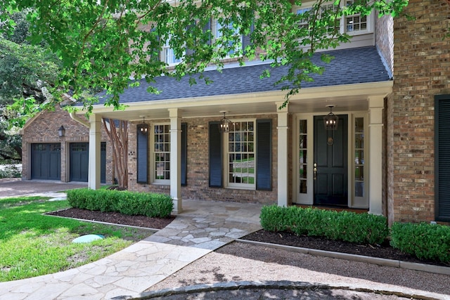 807 Terrace Mountain Dr, West Lake Hills, TX 78746 - view of exterior entry with a porch, brick siding, driveway, and roof with shingles