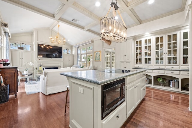 807 Terrace Mountain Dr, West Lake Hills, TX 78746 - kitchen with a breakfast bar area, an inviting chandelier, dark wood-style floors, and black appliances