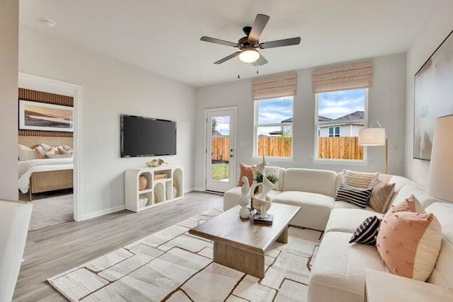 240 Hidalgo Ln, Elgin, TX 78621 - living room with light wood-type flooring, ceiling fan, and baseboards