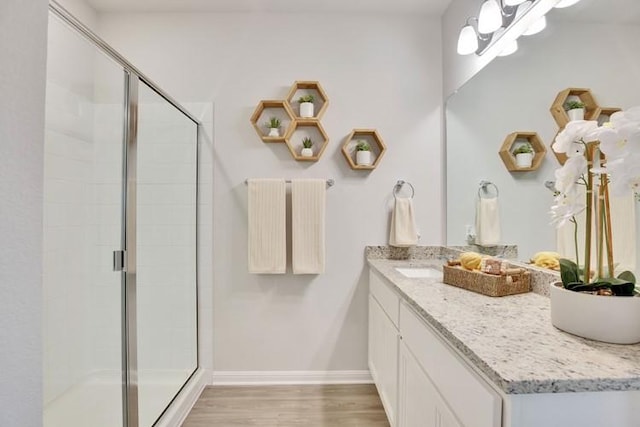 240 Hidalgo Ln, Elgin, TX 78621 - full bath featuring vanity, a stall shower, and wood finished floors