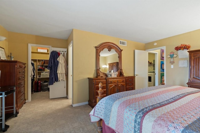317 Venture Blvd S, Point Venture, TX 78645 - bedroom with carpet, a walk in closet, washer / dryer, and a closet