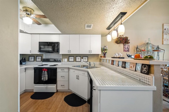 317 Venture Blvd S, Point Venture, TX 78645 - kitchen featuring range with electric cooktop, black microwave, light wood-style floors, a sink, and a ceiling fan
