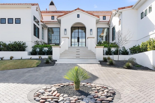 view of front of property featuring a tile roof and stucco siding