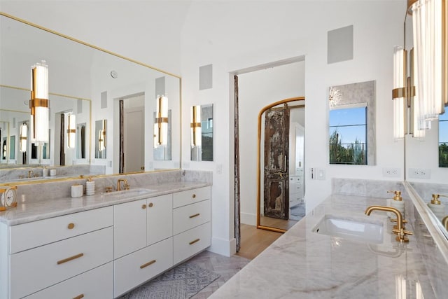 full bath with a garden tub, a towering ceiling, marble finish floor, and vanity