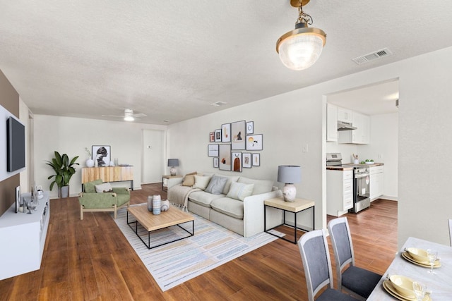 4904 Fm 2984, Luling, TX 78648 - living area with wood finished floors, a textured ceiling, and a ceiling fan