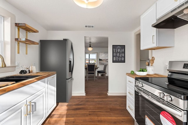 4904 Fm 2984, Luling, TX 78648 - kitchen with appliances with stainless steel finishes, under cabinet range hood, dark wood finished floors, a sink, and butcher block countertops