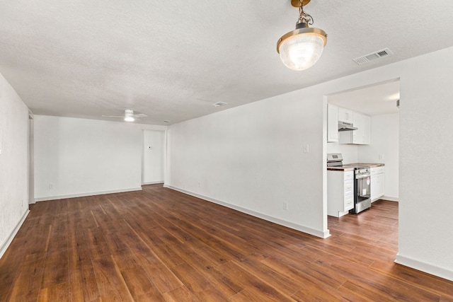 4904 Fm 2984, Luling, TX 78648 - spare room with a textured ceiling, dark wood-style flooring, a ceiling fan, and baseboards