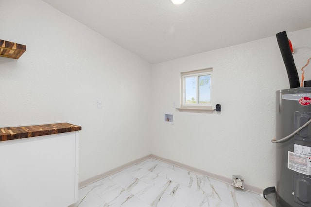 4904 Fm 2984, Luling, TX 78648 - laundry area featuring water heater, light marble finish flooring, hookup for a washing machine, and baseboards