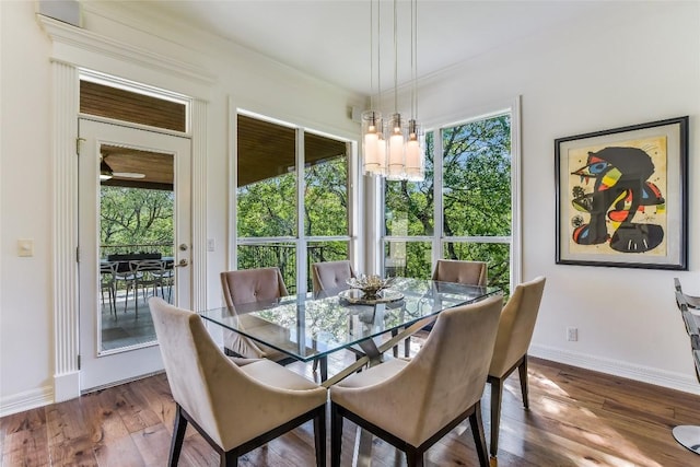 5802 Gentle Breeze Ter, Austin, TX 78731 - dining space featuring a chandelier, healthy amount of natural light, wood finished floors, and ornamental molding