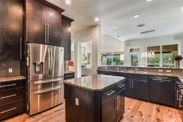 5802 Gentle Breeze Ter, Austin, TX 78731 - kitchen with stainless steel refrigerator with ice dispenser, black dishwasher, a center island, backsplash, and recessed lighting