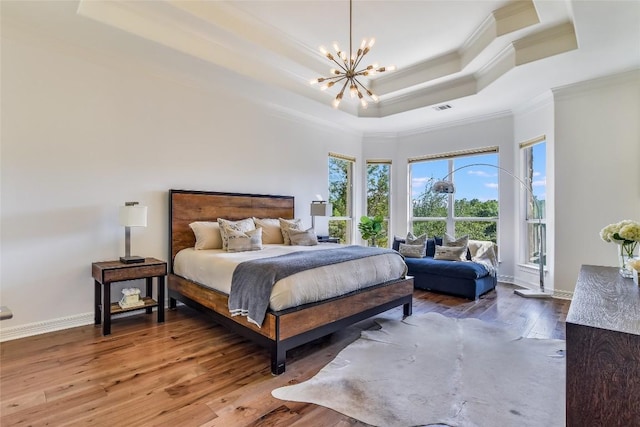 5802 Gentle Breeze Ter, Austin, TX 78731 - bedroom featuring a raised ceiling, ornamental molding, a chandelier, and wood finished floors