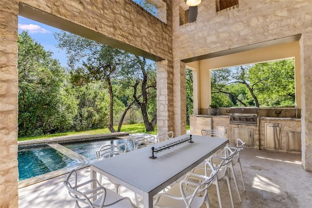 5802 Gentle Breeze Ter, Austin, TX 78731 - view of patio / terrace with an outdoor kitchen, an outdoor pool, view of wooded area, and outdoor dining area