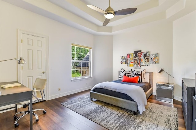 5802 Gentle Breeze Ter, Austin, TX 78731 - bedroom featuring dark wood-style flooring, a raised ceiling, a desk, and a ceiling fan