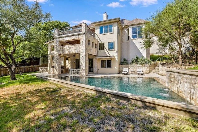 5802 Gentle Breeze Ter, Austin, TX 78731 - back of house with a balcony, stucco siding, stairs, a patio, and a chimney