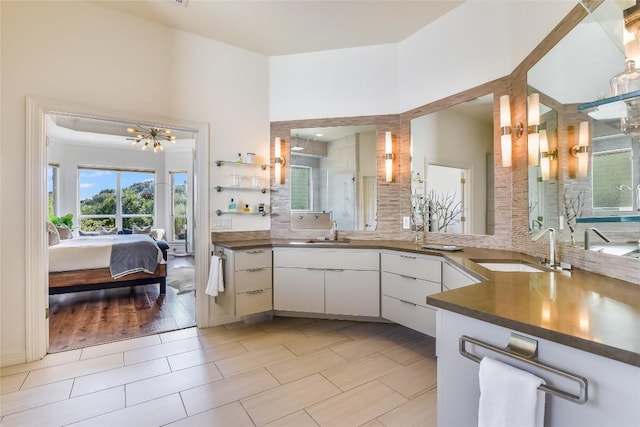 5802 Gentle Breeze Ter, Austin, TX 78731 - ensuite bathroom featuring a chandelier, vanity, tile patterned floors, a shower with shower door, and a high ceiling