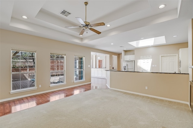 6407 Johanne Ct, Austin, TX 78750 - spare room with a raised ceiling, a skylight, recessed lighting, a ceiling fan, and light carpet