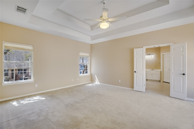 6407 Johanne Ct, Austin, TX 78750 - spare room featuring a raised ceiling, light colored carpet, and a ceiling fan