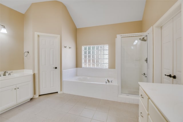 6407 Johanne Ct, Austin, TX 78750 - full bathroom with vanity, a garden tub, vaulted ceiling, a shower stall, and tile patterned flooring