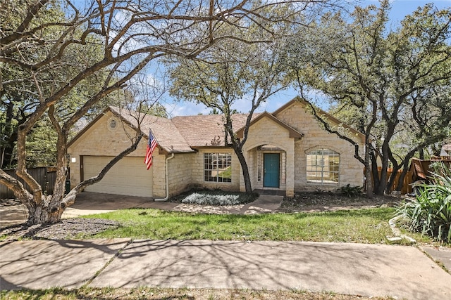 6407 Johanne Ct, Austin, TX 78750 - view of front facade with stone siding, an attached garage, and driveway