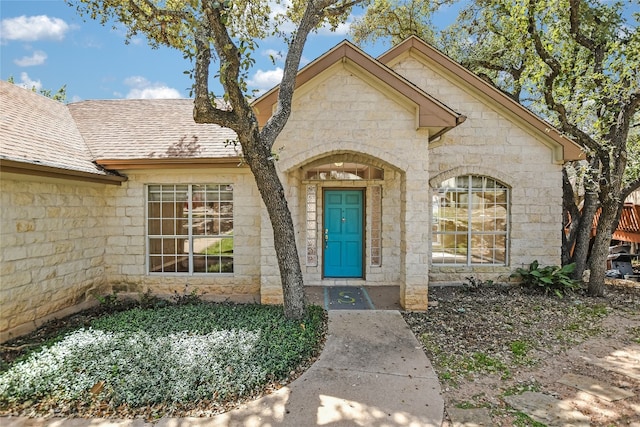 6407 Johanne Ct, Austin, TX 78750 - property entrance featuring stone siding and a shingled roof