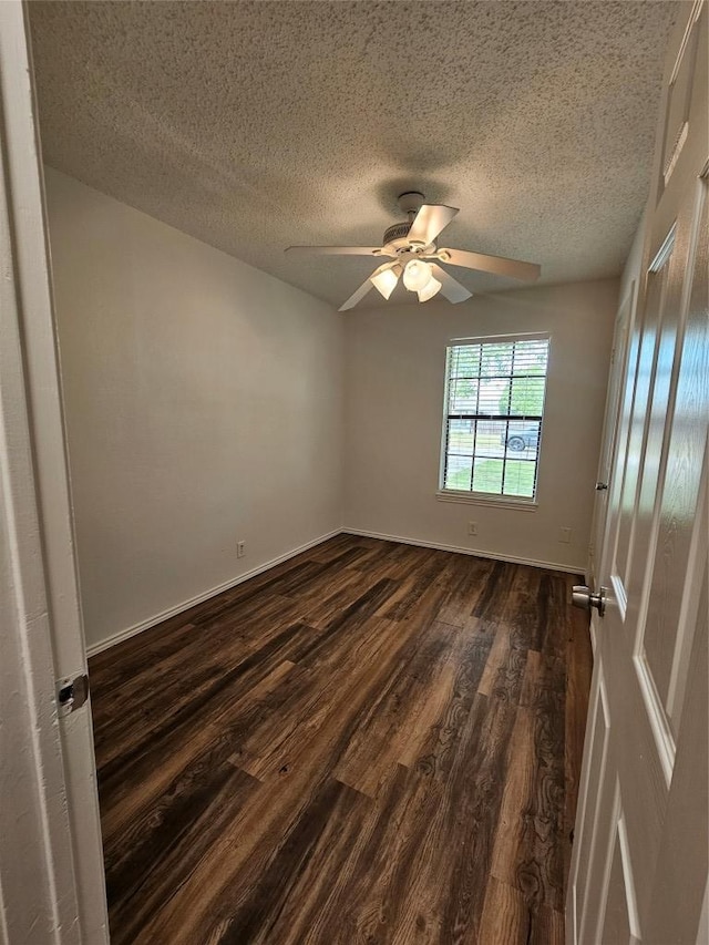 2407 Meadow Brook Dr, Round Rock, TX 78664 - empty room featuring dark wood-style flooring, a textured ceiling, ceiling fan, and baseboards
