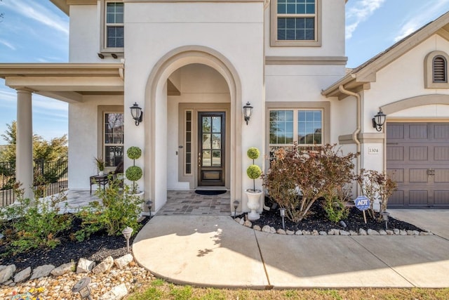 1304 Positano Pass, Leander, TX 78641 - entrance to property with stucco siding, a garage, and covered porch