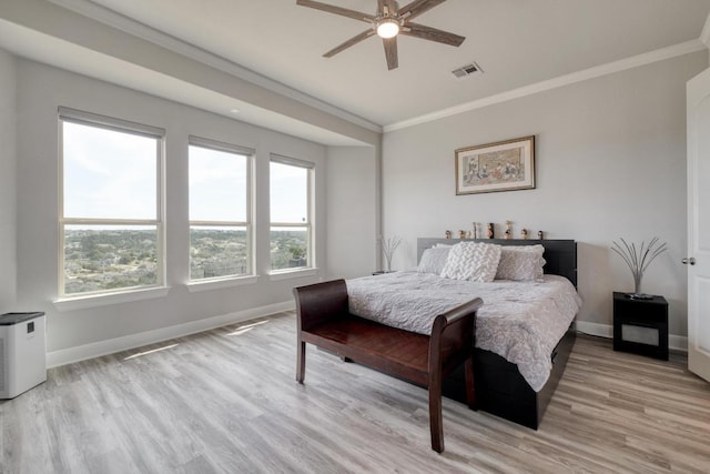 1304 Positano Pass, Leander, TX 78641 - bedroom with light wood finished floors, crown molding, baseboards, and a ceiling fan