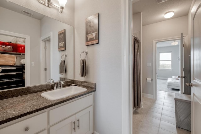 1304 Positano Pass, Leander, TX 78641 - bathroom featuring tile patterned floors, vanity, and baseboards