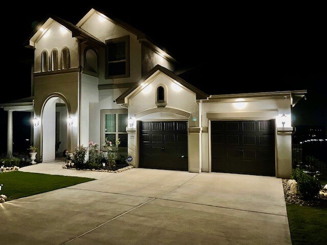 1304 Positano Pass, Leander, TX 78641 - view of front of house with driveway, stucco siding, and a garage