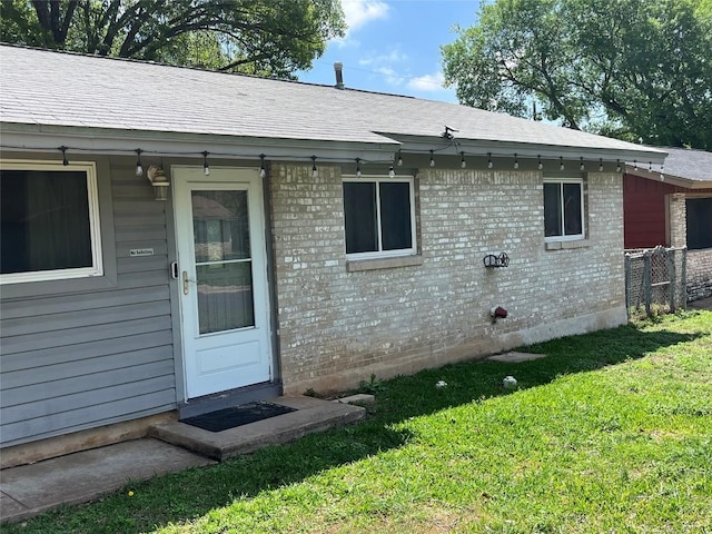 4609 Greenridge Ter, Austin, TX 78745 - entrance to property with a lawn, brick siding, and a shingled roof