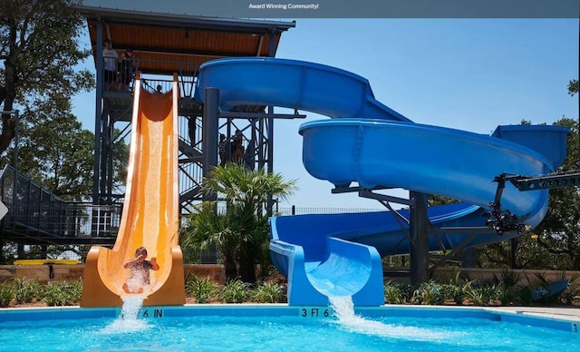 304 Echo Pass, Liberty Hill, TX 78642 - view of jungle gym featuring an outdoor pool