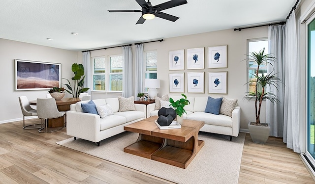 513 Raleigh Dr, Georgetown, TX 78633 - living area with light wood-style floors, ceiling fan, and baseboards