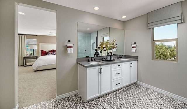 512 Raleigh Dr, Georgetown, TX 78633 - ensuite bathroom with healthy amount of natural light, double vanity, baseboards, tiled shower, and recessed lighting