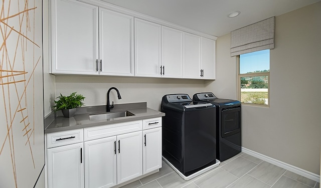 512 Raleigh Dr, Georgetown, TX 78633 - laundry area featuring washing machine and clothes dryer, cabinet space, and baseboards