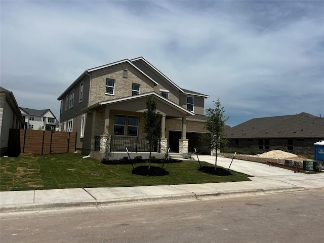 512 Raleigh Dr, Georgetown, TX 78633 - view of front facade with driveway, stone siding, a front lawn, and fence